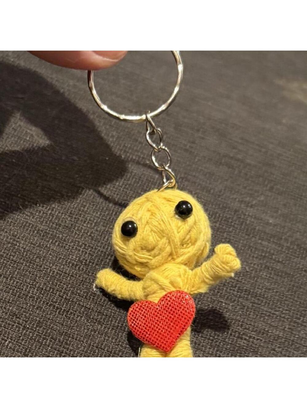 Cute little yarn voodoo keychain. Yellow yarn doll keychain with red heart